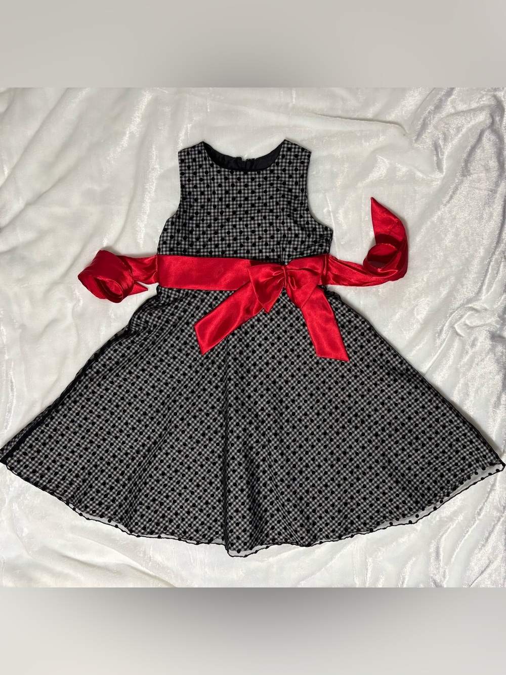 Girls black-white gingham dress with black lace dotted overlay, red bow-front